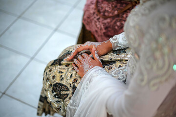 Beautiful Bride Holding Her Hand while Wearing Wedding Dress in a Traditional Wedding Ceremony in Indonesia