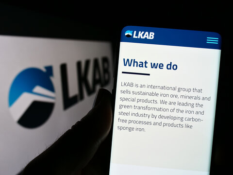 Stuttgart, Germany - 01-12-2023: Person holding cellphone with webpage of company Luossavaara-Kiirunavaara AB (LKAB) on screen in front of logo. Focus on center of phone display.