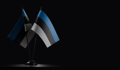Small national flags of the Estonia on a black background