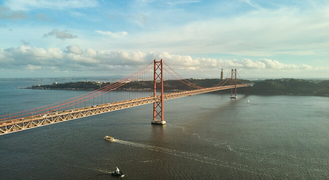 Aerial view of 25th April Bridge in Lisbon, Portugal. Famous landmark on river Tagus. High quality photo