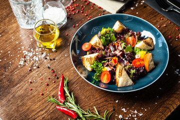 Warm chicken liver salad with port wine-honey sauce. Carrot cream, bacon, cherry tomatoes, brioche. Delicious healthy traditional food closeup served for lunch in modern gourmet cuisine restaurant