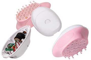 A new battery operated scalp massage brush, shampoo brush or scalp massager for exfoliating and massaging the scalp and a opened damaged old massager. Beauty and health concept.