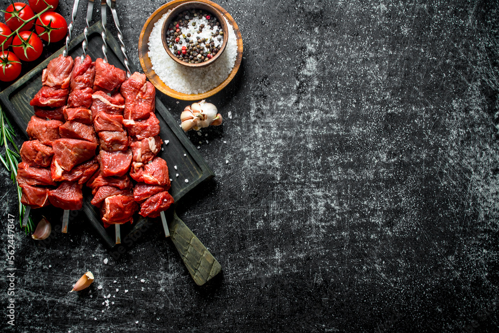 Canvas Prints raw kebab with tomatoes, spices and garlic cloves.