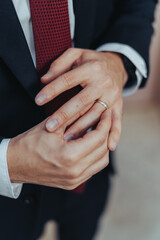 Obraz premium Young Groom is Putting his Wedding Ring on his Finger