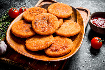 Fish cutlets on a plate with thyme,garlic and tomato sauce.