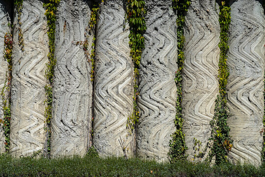 Artful wall made of congrete columns outside