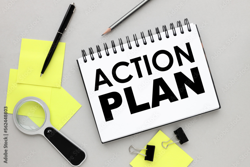 Poster action plan. top view of open notepad with yellow sticky notes