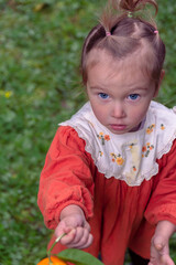 Photo of a girl in the garden among fruit trees.