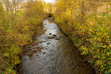 Little creek across the mountain countryside in autumn