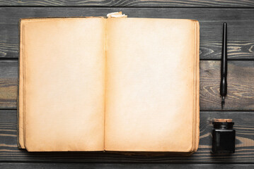 Open blank page book with copy space and ball pen on the wooden table flat lay table background.