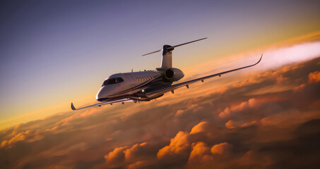 A luxury private jet overflying cloudy skies at sunset - obrazy, fototapety, plakaty