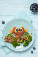 Funny owl chicken cutlet, carrot and broccoli with soba noodles for kids lunch