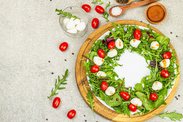 Charcuterie wreath made with mozzarella, cherry tomato, arugula. Fashionable snack, vegetarian food