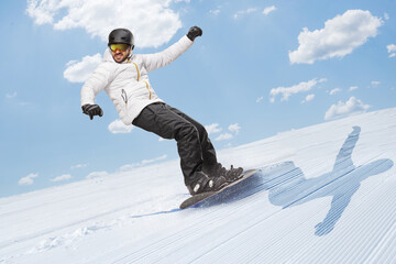 Full length shot of a man gliding with a snowboard downhill