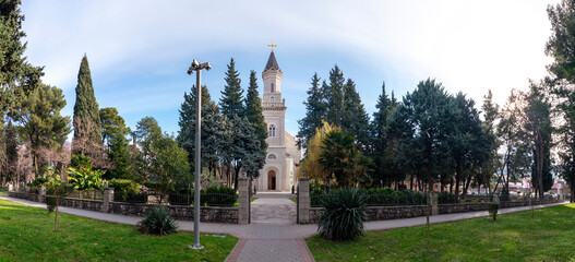 The Orthodox Church of The Holy Transfiguration of God with tall belltower full territory wide panorama front view