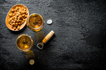Beer in glasses and crumbs on a plate.