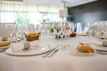 Wedding reception photo. Glasses and flowers on tables. 