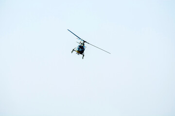 Fototapeta na wymiar Combat Helicopter is going to attack enemy. Helicopter is flying on isolated blue sky