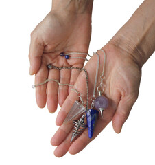 Female dowsing practitioner holding four radionics pendants in an offering gesture transparent png...
