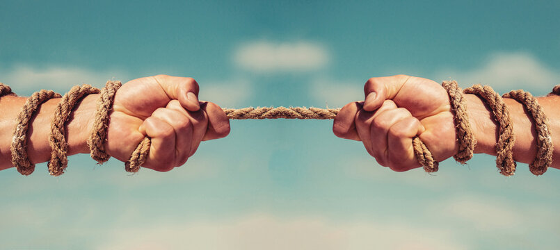 Two hands, helping hand, arm, friendship. Rope, cord. Rescue, help, helping gesture or hands. Conflict tug of war