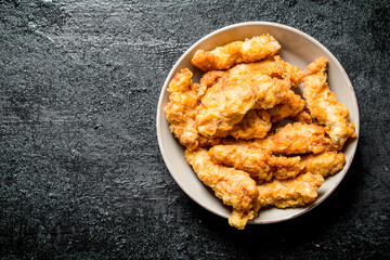 Chicken strips in bowl.