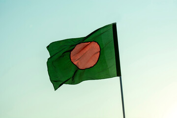 Bangladesh flag is flaying in isolated blue sky