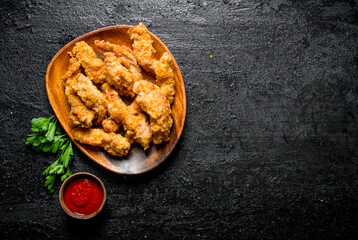 Chicken strips with tomato sauce and parsley.
