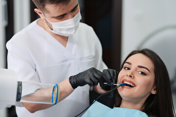 Overview of dental caries prevention. Girl at the dentist's chair during a dental procedure....