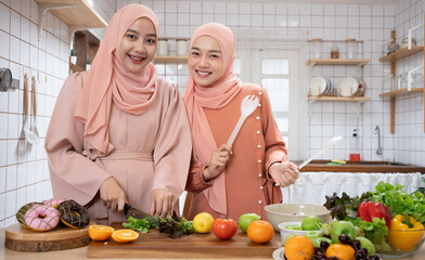 Women Muslim Friends Chef Cook a Healthy organics vegetable foods Cooking Concept.