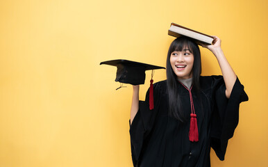Smile Asian student woman Cheerful graduating with Yellow background, great for your text, asian...