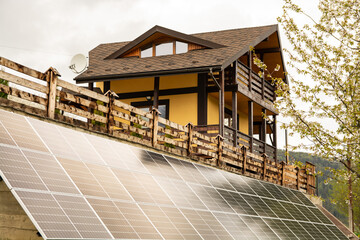 Solar batteries eco house green energy.Solar power plants in the field near the forest. An alternative way of obtaining energy.