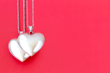 Two pendants in the form of a heart on a red background