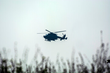 Silhouette of helicopter take off from a ground.