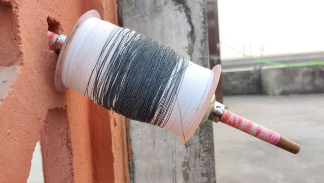 Footage of a charkha shot during sunset. Thread for flying paper kite. Makar Sankranti kite flying festival. Independence Day celebration.
