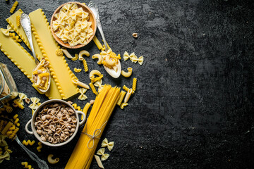 Different types of pasta dry the spoon and bowl.