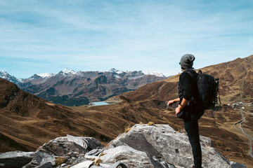 Man overlooking tall mountains in the swiss alps