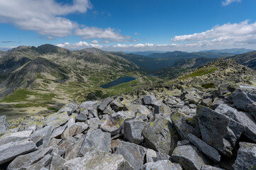 wide view of tna mountains in romania with lake in valley in carpathians in retezat mountains in romania