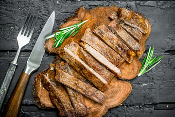Grilled sliced beef steak with rosemary.