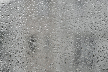 Raindrops on glass, blurred city background, mediterranean rainy season, travel and holiday idea