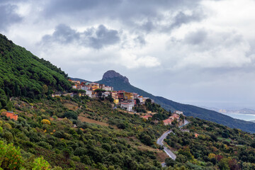 Fototapeta na wymiar Small Touristic Town, Baunei, in the Mountains of Sardinia, Italy. Cloudy Rainy Day. Fall Season