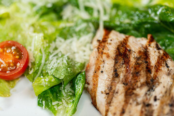 food and eating concept - close up of chicken with vegetable salad on plate