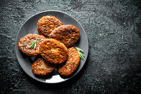 Cutlets on a plate with rosemary.