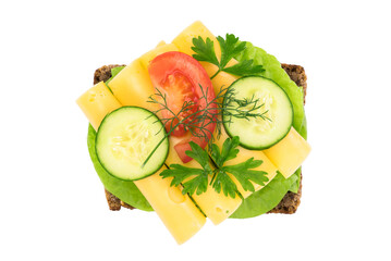 Top view of a healthy sandwich with dark full grain rye bread, vegetables and cheese isolated on a transparent background.