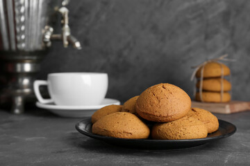 Delicious oatmeal cookies on grey table. Space for text