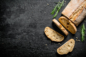 Pieces of bread ciabatta with rosemary.