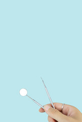 Different tools for dental care in woman hand. Dental background. With copy space, close-up. Oral dental hygiene concept.