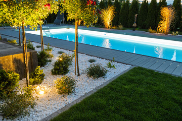 Residential Outdoor Swimming Pool Illuminated by LED Lights - 562488657