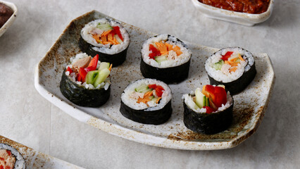 Homemade futomaki sushi rolls with vegetables and canned tuna fish.