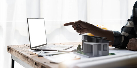 Civil engineer teams meeting working together wear worker helmets hardhat on construction site in modern city. Foreman industry project manager engineer teamwork. Asian industry professional team.