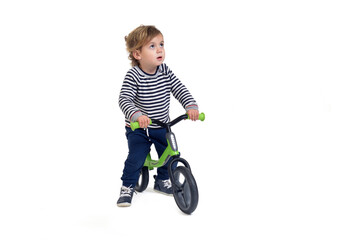 baby boy bicycling a bicycle and looking up on white background